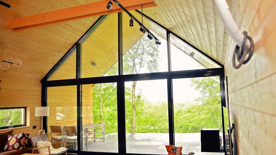 The living space one one side has a large window opening from top to bottom