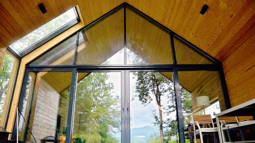The terrace and the living space are separated by a large window