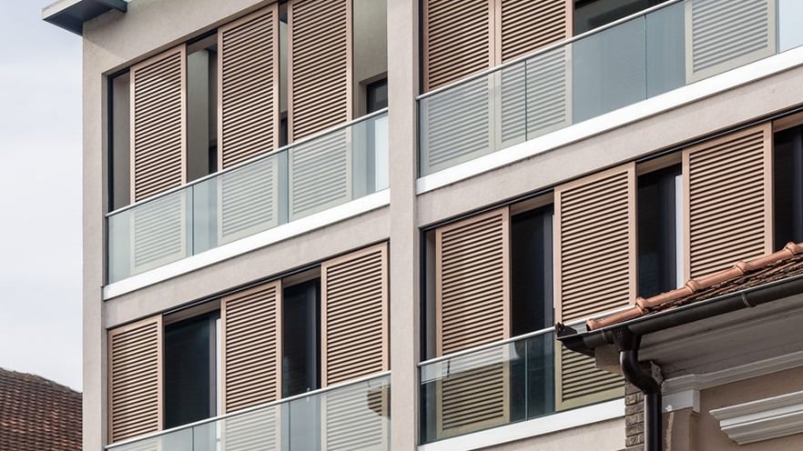 The balconies have glass railings