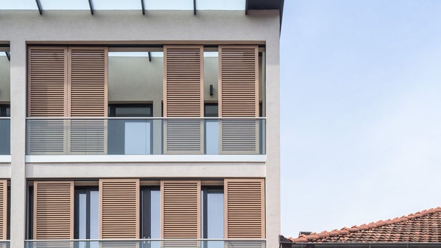 A set of shutters provides shading to the balconies