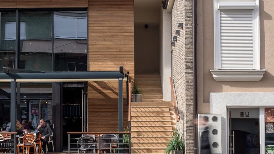 The staircase that leads to the residences is located in between the two buildings