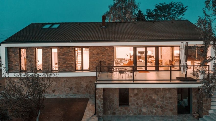 The back of the stone house with the balcony