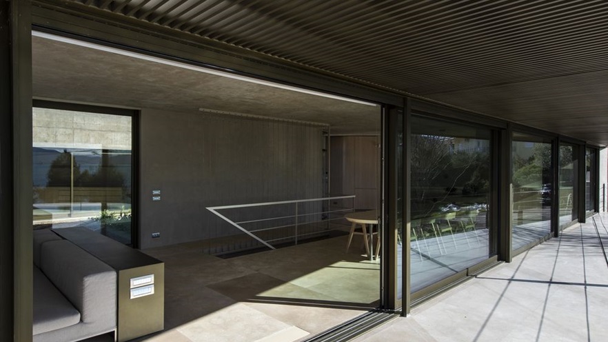 The living area hosts the sitting and the dinning area with large windows