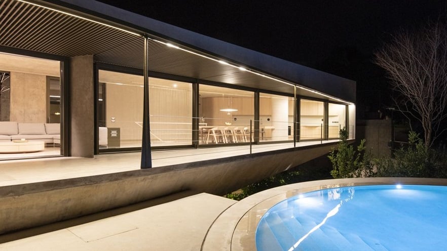 The house has a large terrace that overlooks the pool