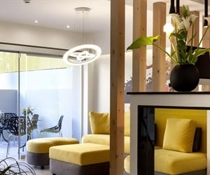 The lobby with a yellow sofa and wooden details