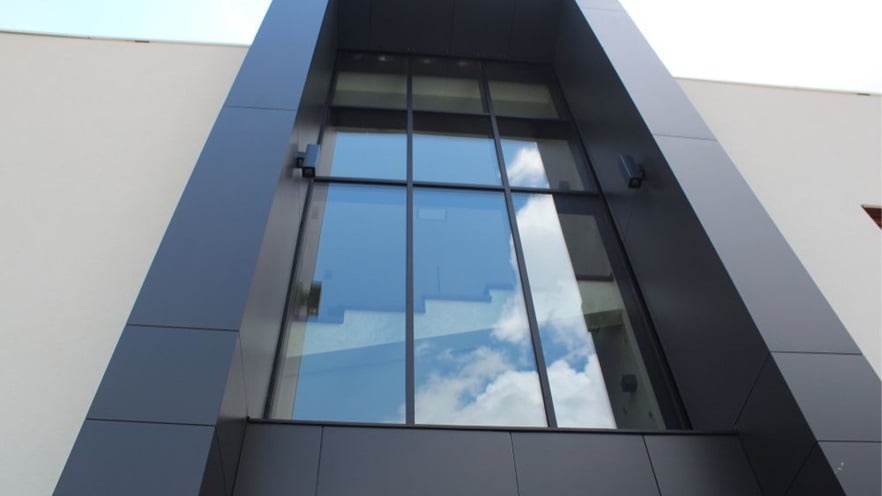 The glass façade in the front of the building