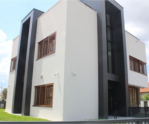 The white villa with the dark and brown details