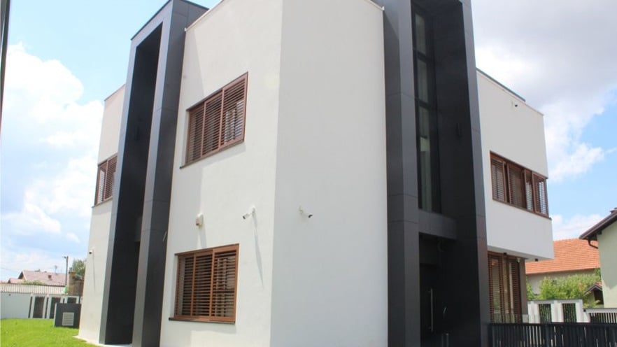 The white villa with the dark and brown details