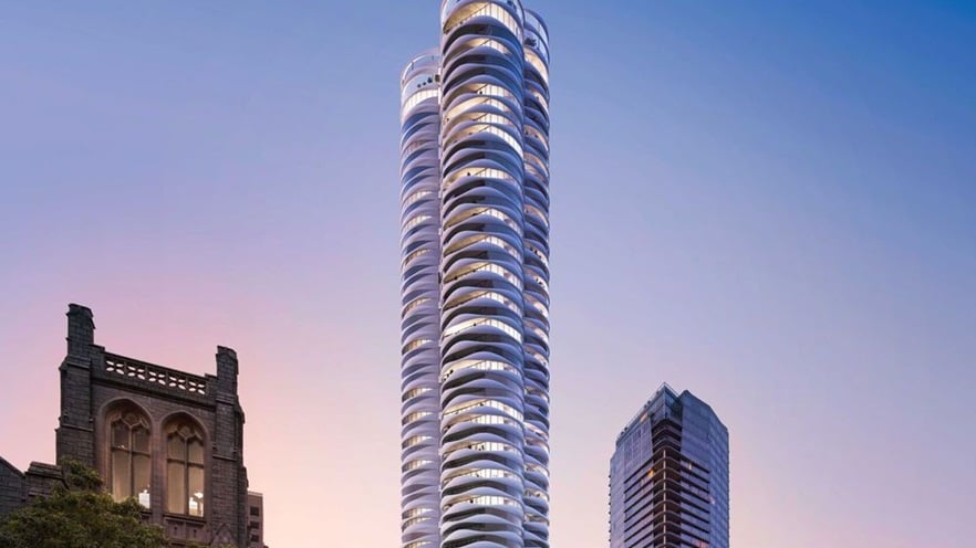 The building stands tall between a church and an another tower