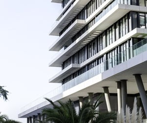 The corner of the building with glass railings and the curtain wall