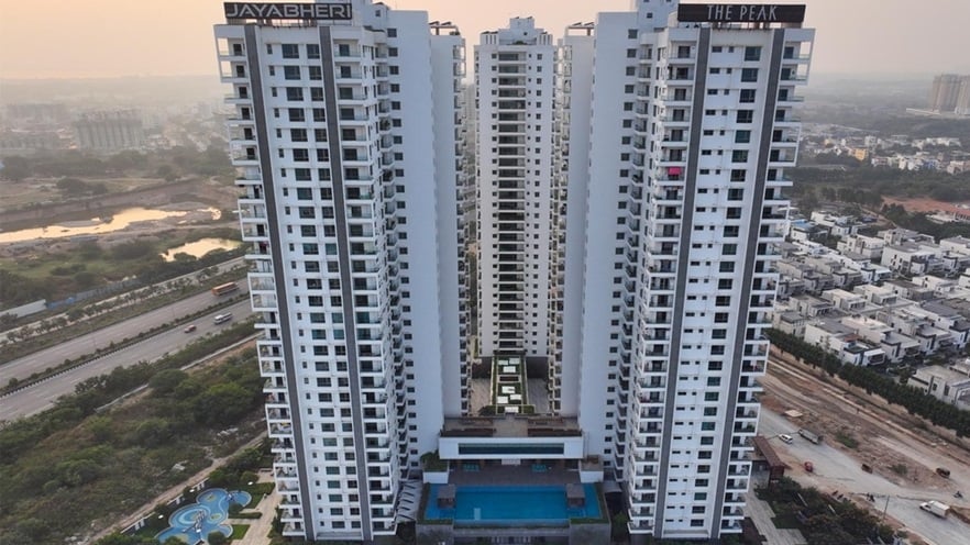 The three towers are white and provide many balconies and windows