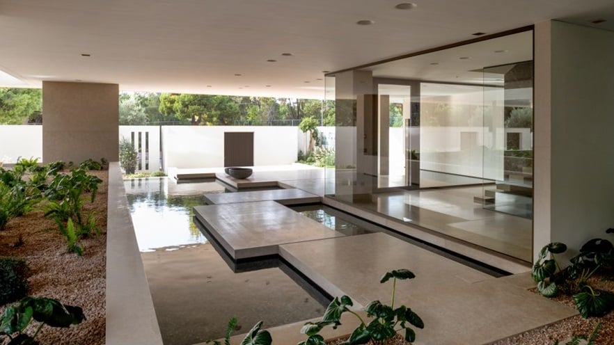 The lobby has plants, water & concrete details