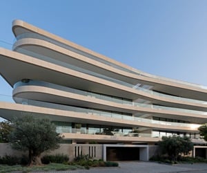 A multi-storey building with large curvy balconies