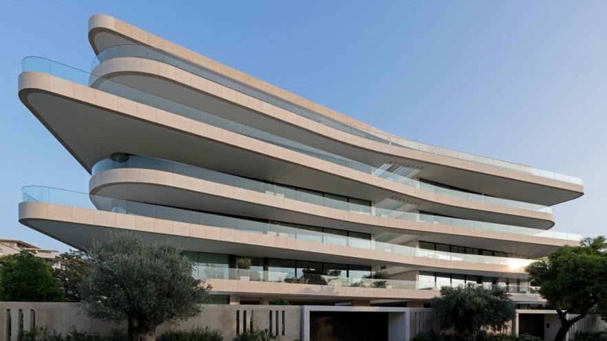 A multi-storey building with large curvy balconies