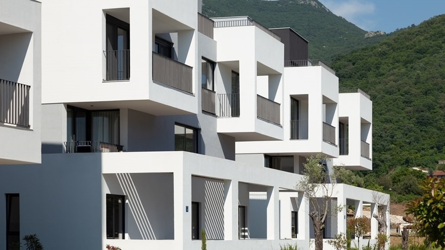 The ground floor has sheltered terraces and the upper levels have balconies