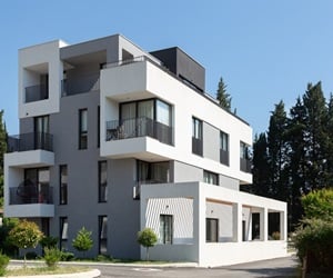The building is surrounded by trees and plants