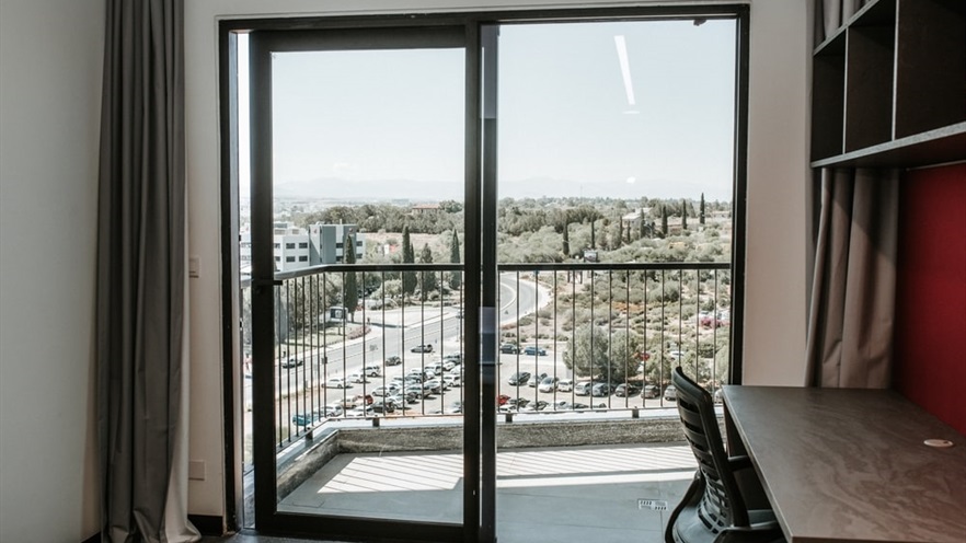 Room balcony with view to the parking and the park