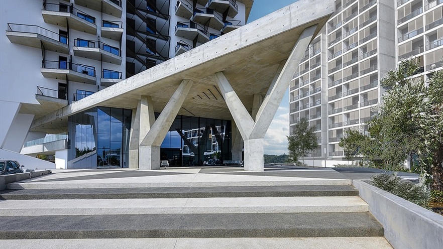 Entrance of the building with a large triangle made of concrete