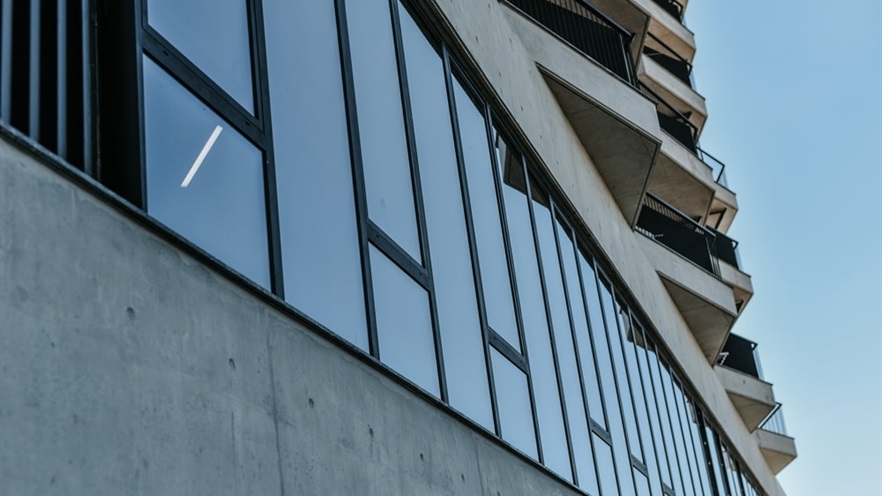 Close up to the glass façade and balconies on top