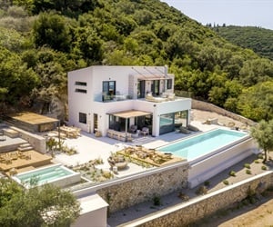 A two-storey building with outdoor spaces, including a pool.