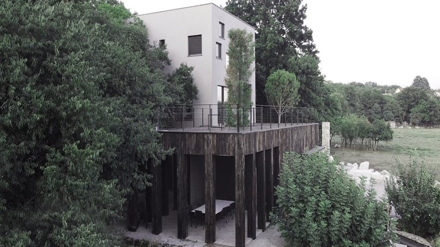The villa is surrounded by trees