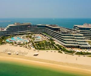 The large multi-storey building with pools and the beach