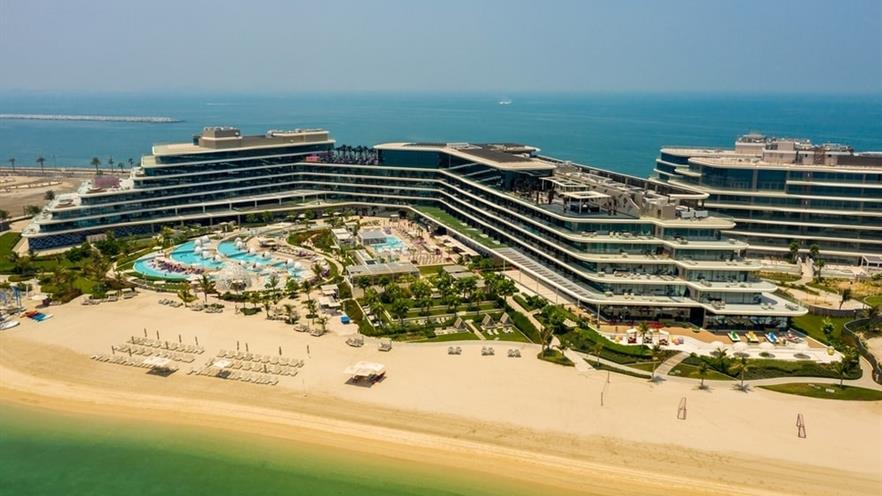 The large multi-storey building with pools and the beach