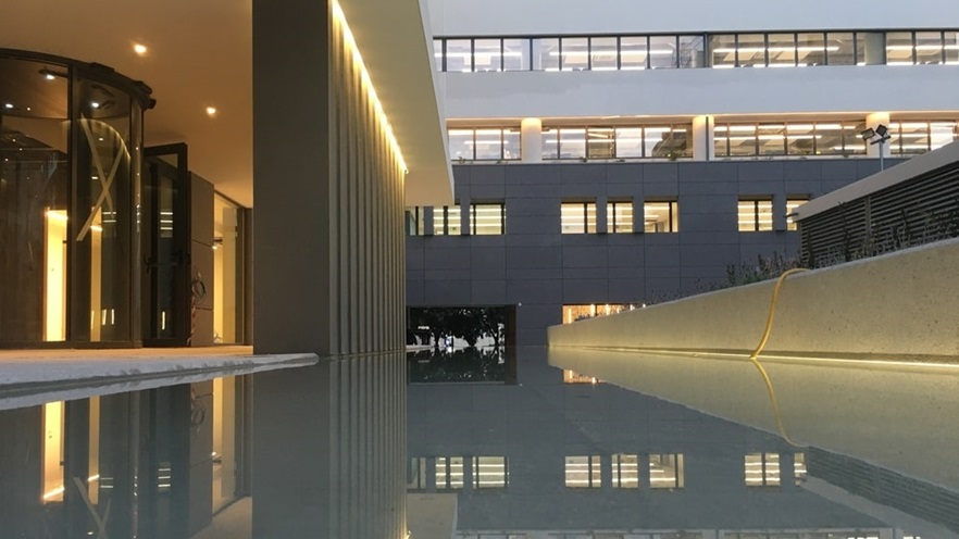 On the exterior there are columns and a decorative pool with water