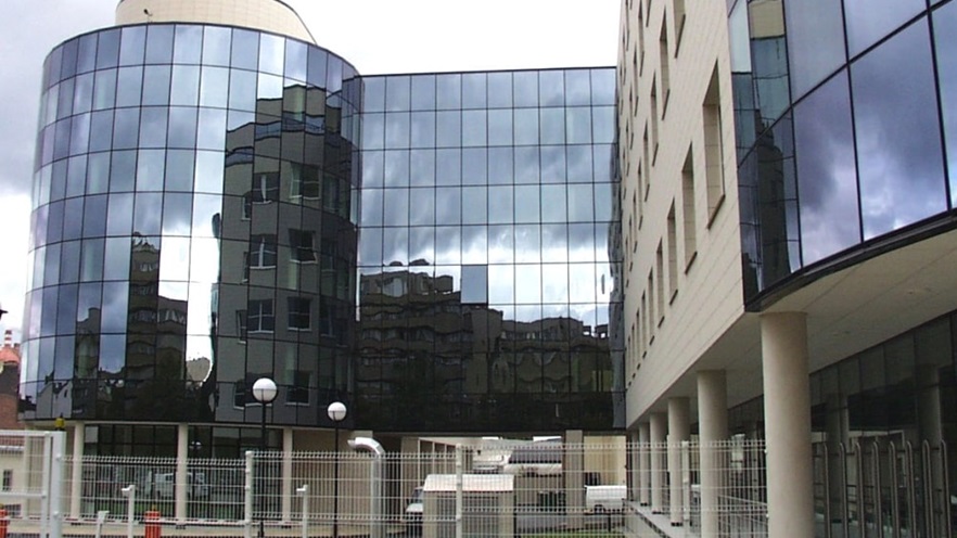 The building on the ground level has many columns all around its perimeter