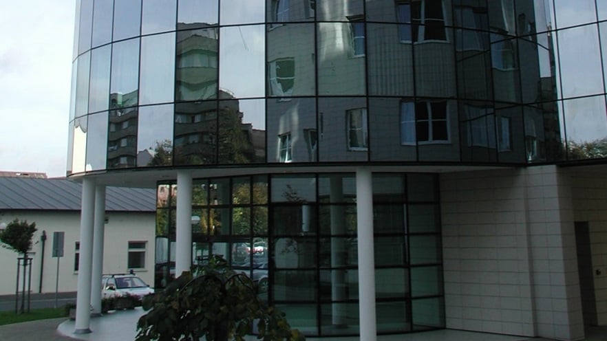 The building's entrance has columns and a curtain wall