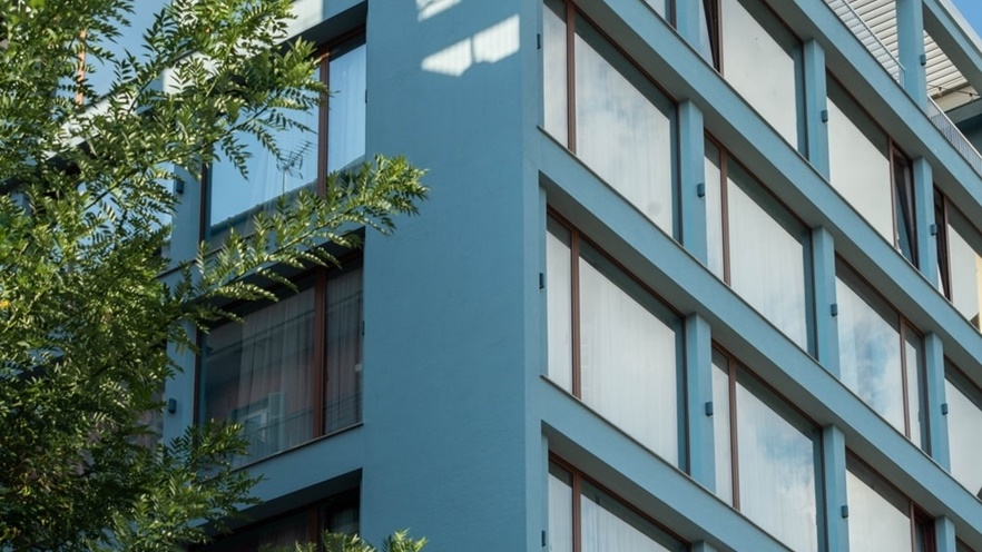 The building has large windows that close with curtains